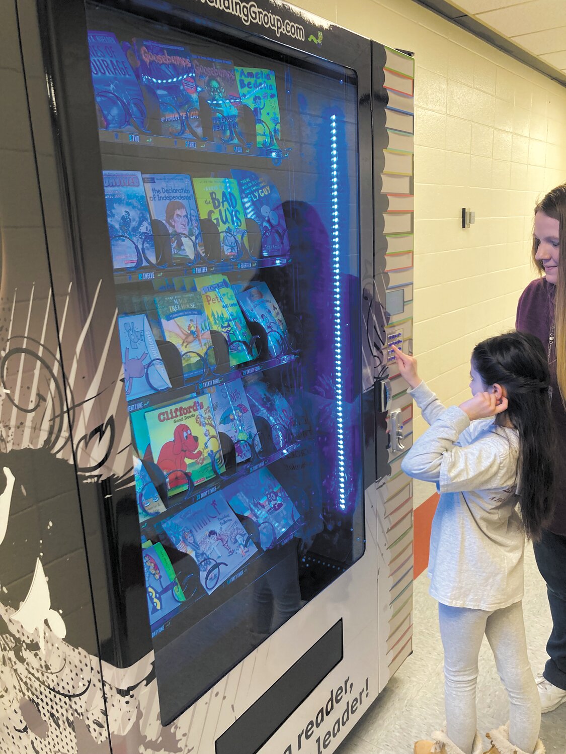 READING MACHINE: Following the assembly, Kidd gave Hoxsie’s book vending machine a visit. She ended up buying “Bluey: The Pool,” a book based off of popular children’s TV show Bluey.